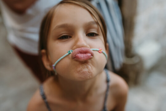 Close Up Portrait Of Girl Making A Kissing Face
