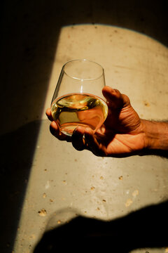 Hand of an African American Man Holding a Glass of Wine 