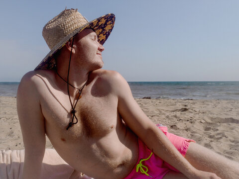 Young handsome guy on the beach