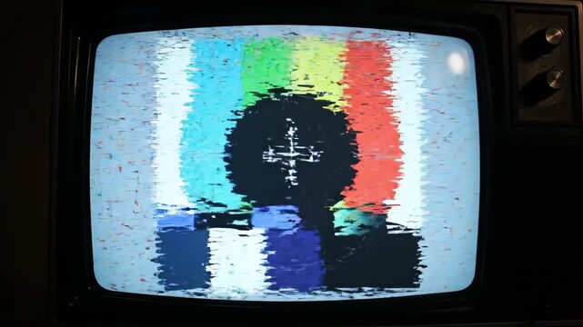 Vintage TV screen displaying colorful static noise image  