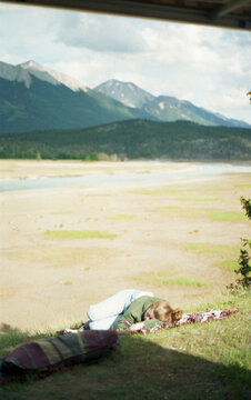Woman taking a nap on the grass.