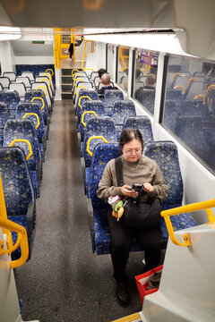 Sydney Train Car With Passengers Engaging with smartphone