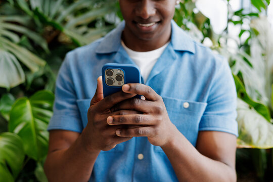 Hands Holding Phone in Greenery Setting