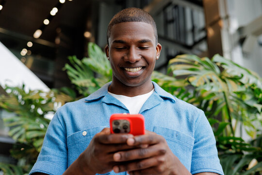 Businessman Using Red Phone in Office Garden