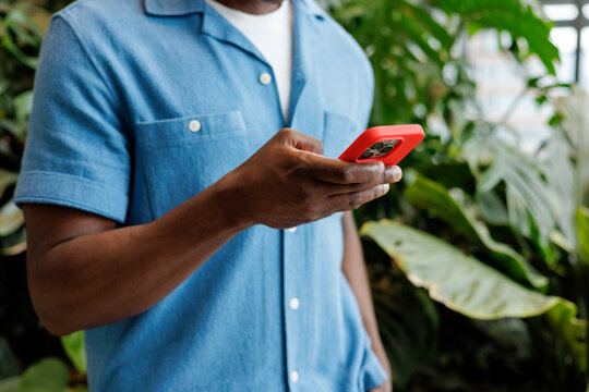 Business Communication on Red Smartphone in Office Garden
