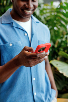 Businessman Holding Red Smartphone at Work