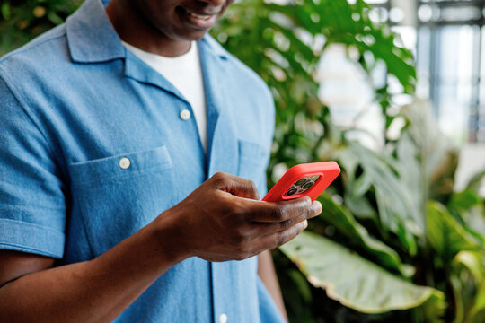 Business Communication on Red Smartphone in Office Garden
