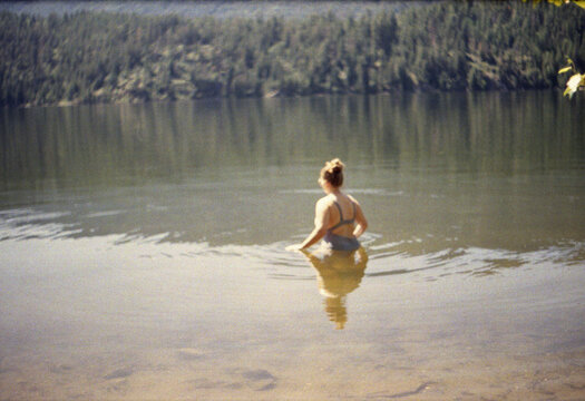 Woman in a lake in Jasper area, Alberta, Canada.
