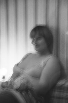A woman sitting in a soft light