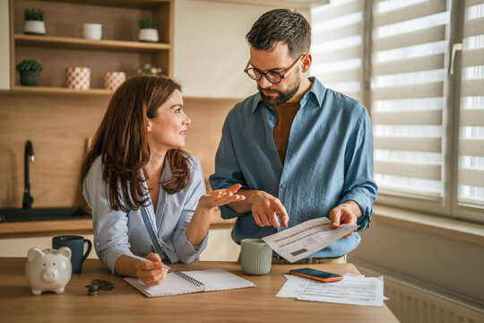 Couple discussing monthly budget and managing household finances