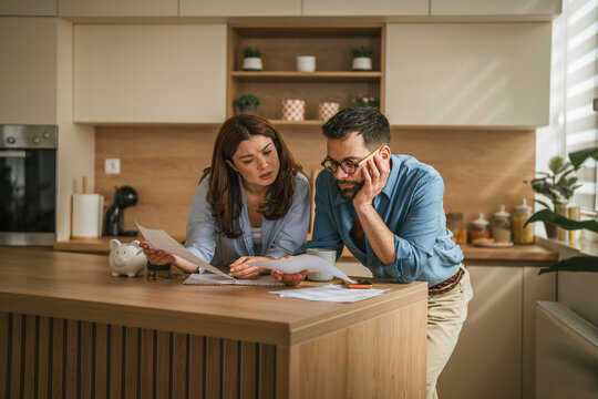 Couple working on household budget, managing financial stress