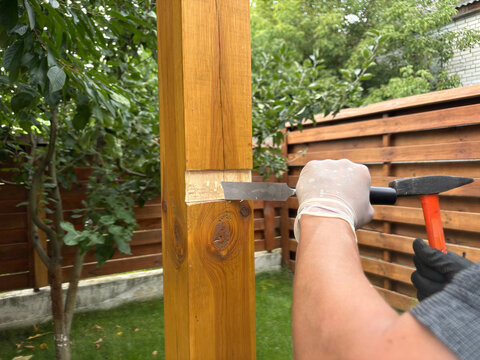 a man is making a wooden terrace