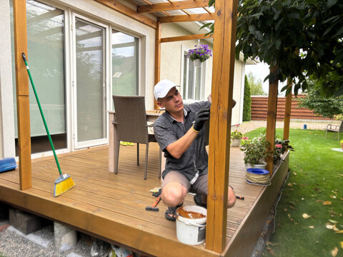 a man is making a wooden terrace