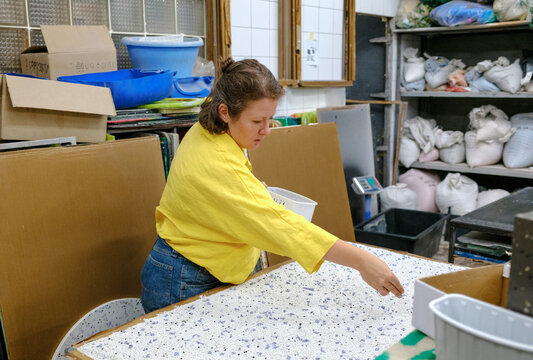 woman working with plastic in a factory