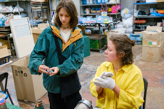 hands of a woman in gloves working with hot plastic