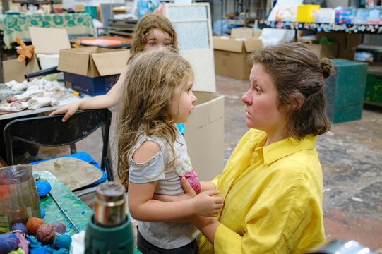 woman with two children at work