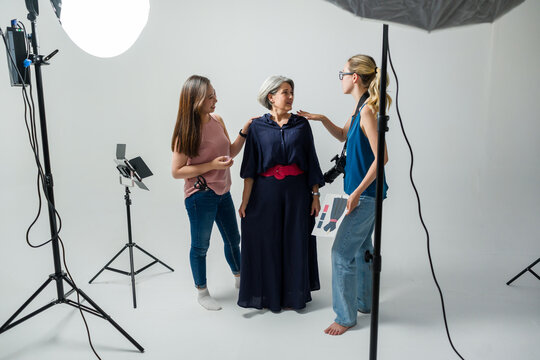 Professional team working during photoshoot in modern studio