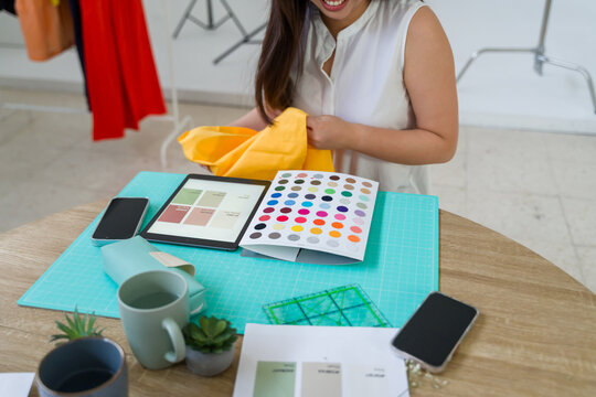 Fashion designer choosing fabric color matching pantone 
