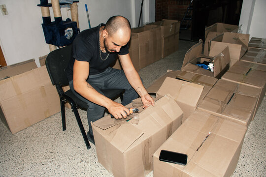 Unpacking boxes in a living room during daylight hours