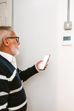 Thermostat With Smartphone in Modern Home