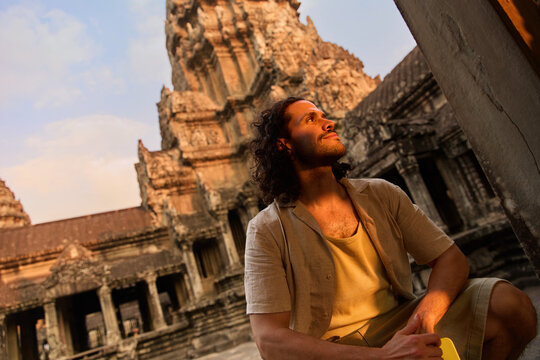 Man seated near Angkor Wat wall