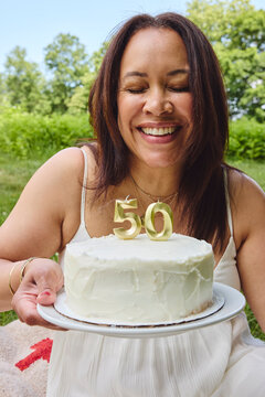 Beautiful black woman celebrating birthday with a cake