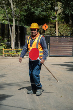Construction worker directing traffic in urban area during daylight