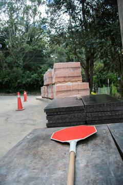 Construction area with warning signs and stacked materials in forest