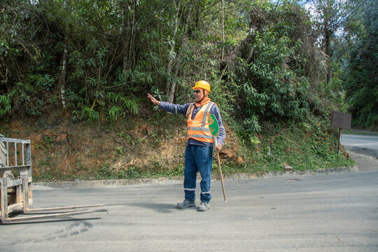 Construction worker directing traffic in a rural area