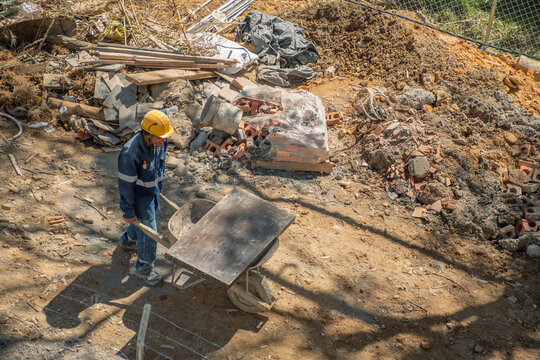 Construction worker transporting materials on a job site