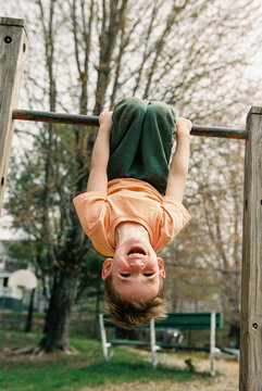 Happy upside-down child at playground