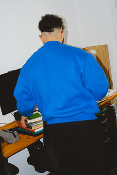 Man Organizing Desk Workspace