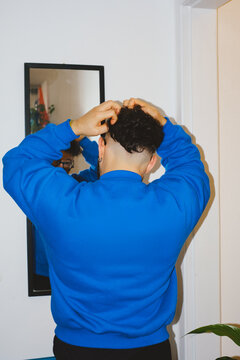 Man Fixing Hair in Mirror