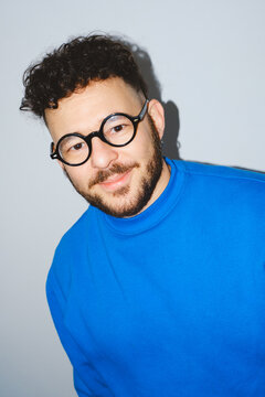 Man in Blue Sweater with Round Glasses