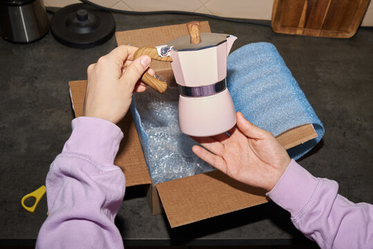 Unboxing a new coffee maker at home
