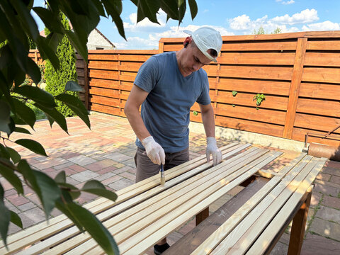 man paints boards