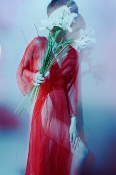 Fashion Portrait of Woman in Red with White Flowers