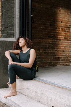 Minimal Portait of Woman Sitting on Stoop 