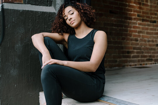 Minimal Portait of Woman Sitting on Stoop 