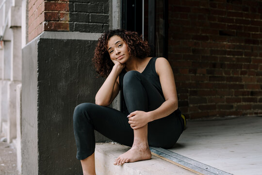 Minimal Portait of Woman Sitting on Stoop 