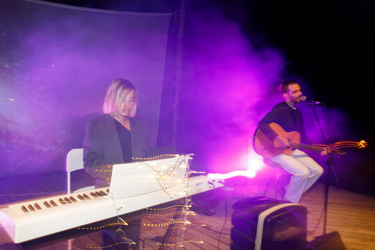 Duet of pianist and guitarist at a night performance