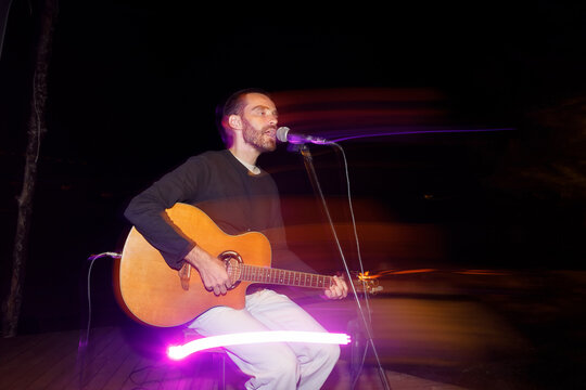 Musician sings a song on the night stage
