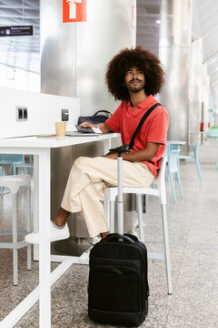 Traveler Laptop and passport at Airport Terminal