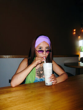Tattooed Individual Drinking Bubble Tea