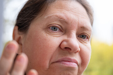skeptical mature woman Outdoors, female face shows frustration, skepticism, and emotional pain...