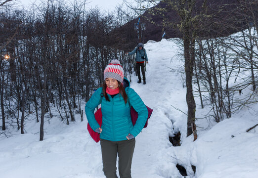 Winter Hiking Adventure in Snowy Forest With Two Explorers