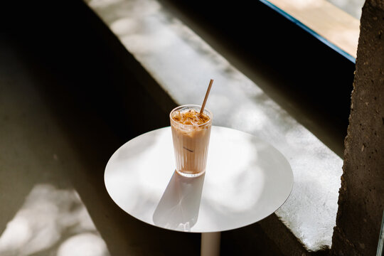 Close-up of a chai latte resting on a caf&eacute; table