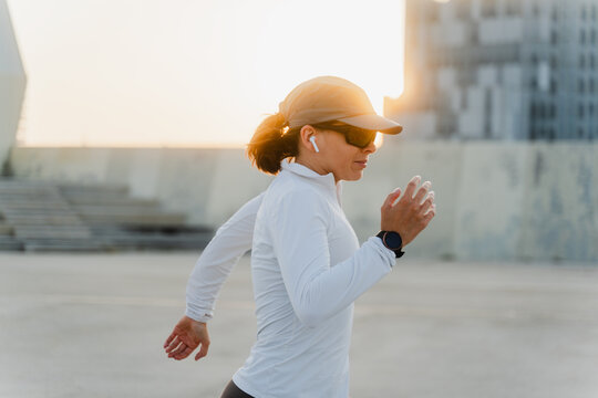 Woman exercising at sunset