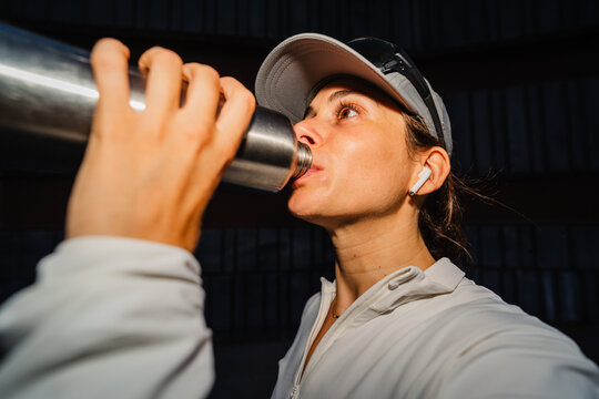 Athlete drinks water from a bottle