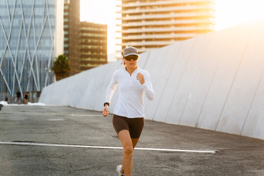Sportswoman runs at sunset